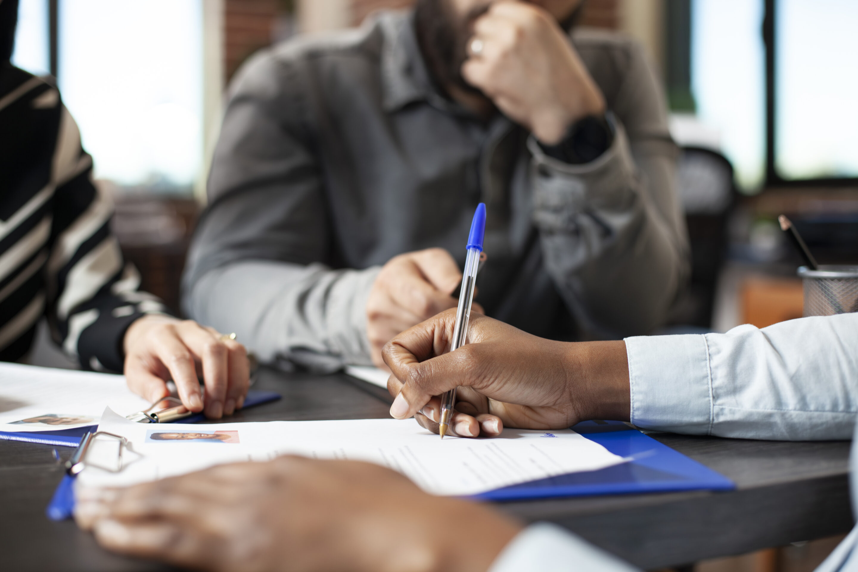 Black person signing job offer paperwork